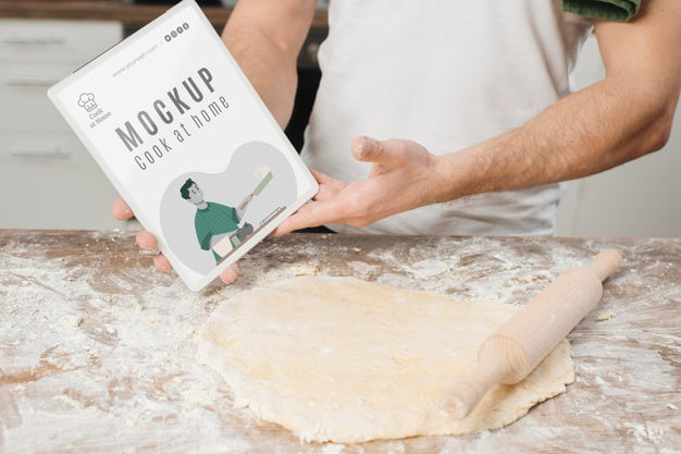 Free Man Rolling Dough In The Kitchen And Holding Book Psd