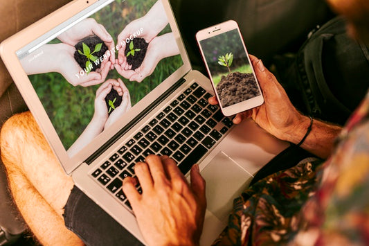 Free Man Using Laptop And Smartphone Mockup With Nature Concept Psd