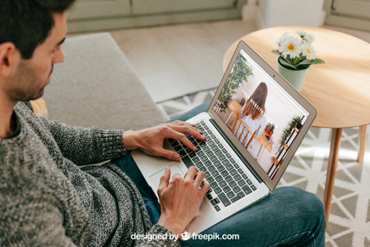 Free Man Using Laptop In Living Room Psd