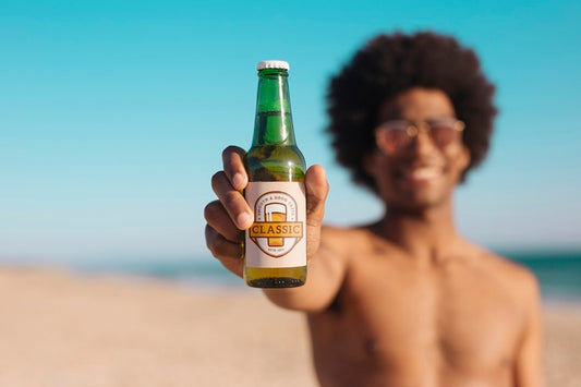 Free Man With Beer Bottle Mockup At The Beach Psd