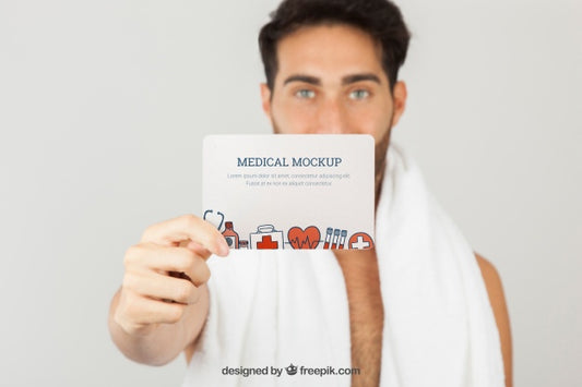 Free Medical Mock Up With Young Man Holding Card Psd