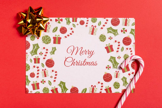 Free Merry Christmas Mock-Up Paper With Sugar Cane And Bow Psd