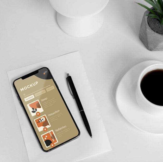 Free Mobile On Desk With Cup Of Coffee Psd