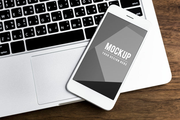 Free Mobile Phone On A Laptop Mockup Psd