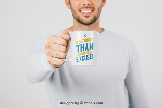 Free Man Holding a Blank Coffee Mug Mockup