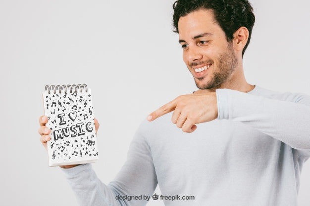 Free Mock Up Design With Smiley Man Pointing The Notebook Psd