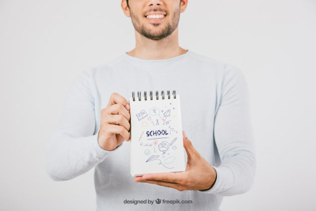 Free Mock Up Design With Young Man Holding Notebook Psd