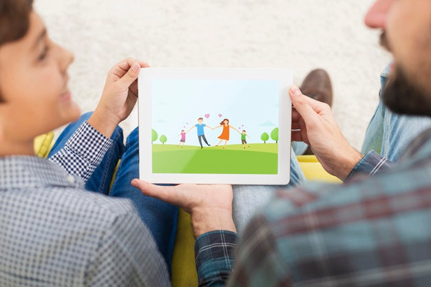 Free Mock-Up Father And Son Watching On Tablet Psd