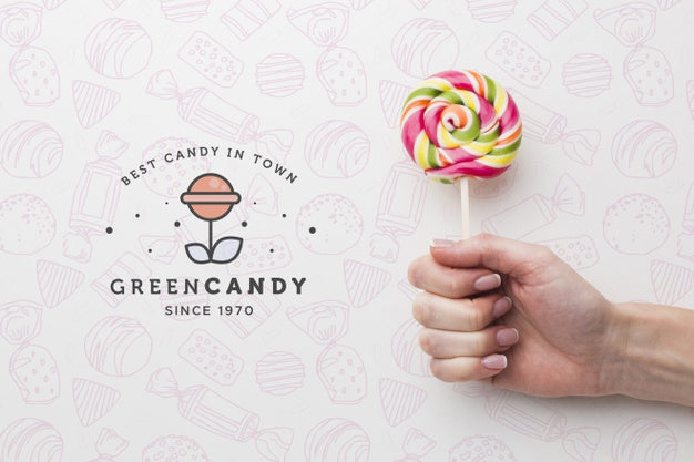 Free Mock-Up Hand With Tasty Lollipop Psd