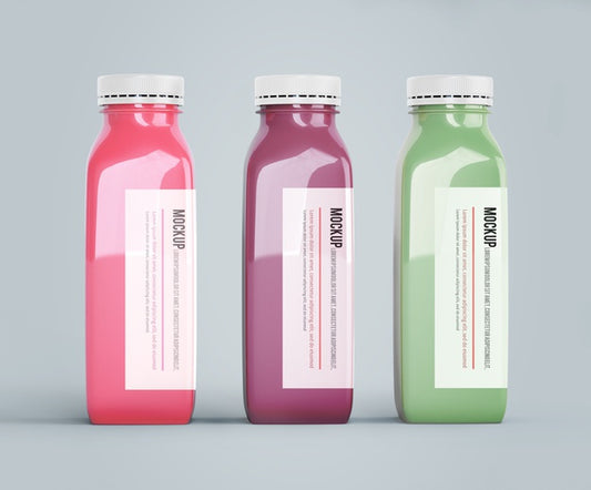 Free Mock-Up Plastic Bottles With Different Fruit Or Vegetable Juices Psd