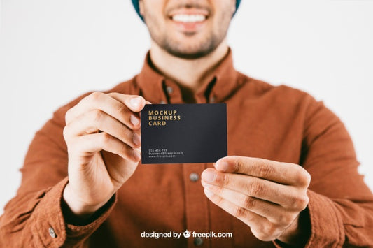 Free Mock Up With Young Man And Business Card In Foreground Psd