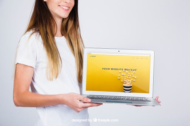 Free Mockup Concept Of Woman Holding Laptop Psd