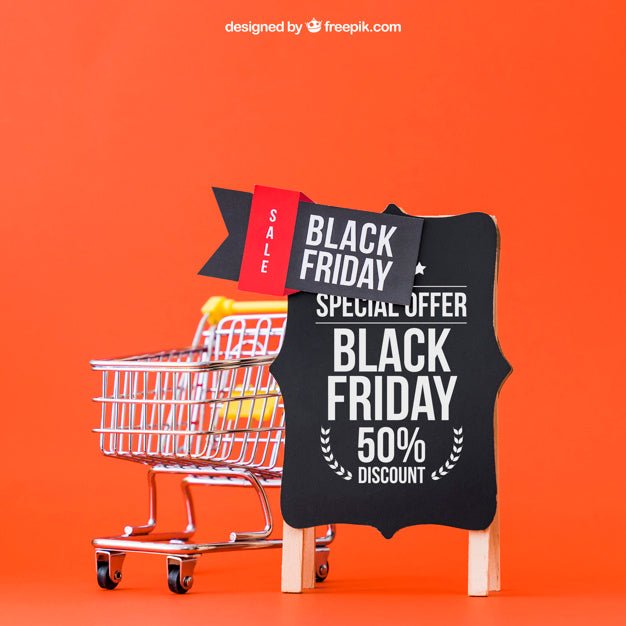 Free Mockup For Black Friday With Cart Next To Board Psd