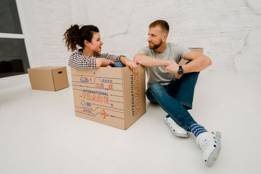 Free Mockup Of Couple With Cardboard Boxes Psd