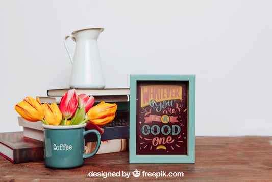 Free Mockup Of Frame Next To Flowers In Mug Psd