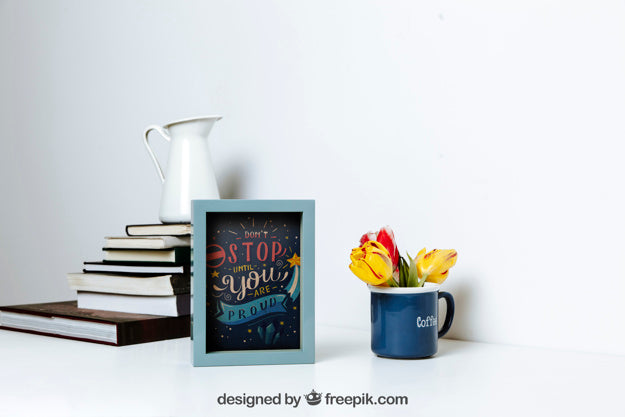 Free Mockup Of Frame Next To Stack Of Books Psd