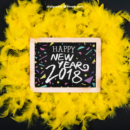 Free New Year Mockup On Yellow Feathers With Slate Psd