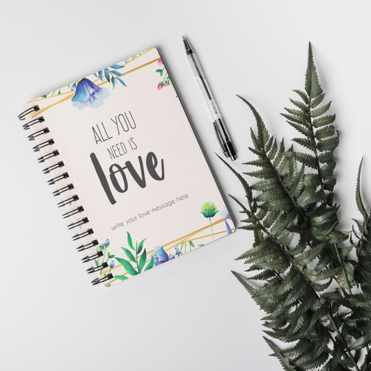 Free Notebook Mockup Next To Leaves Psd