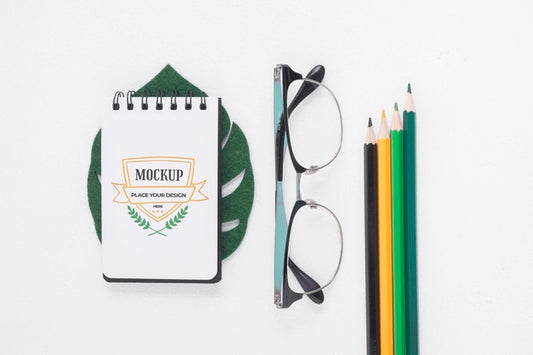 Free Notepad Mock-Up Next To Stationery Elements Psd