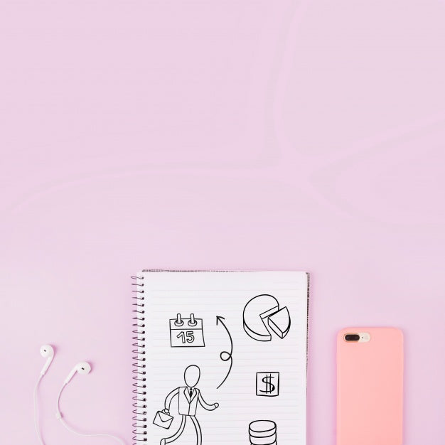 Free Notepad Mockup Next To Smartphone And Earphones Psd