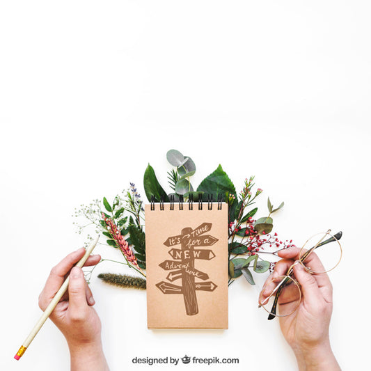 Free Notepad Mockup With Hands And Leaves Psd