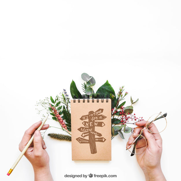 Free Notepad Mockup With Hands And Leaves Psd