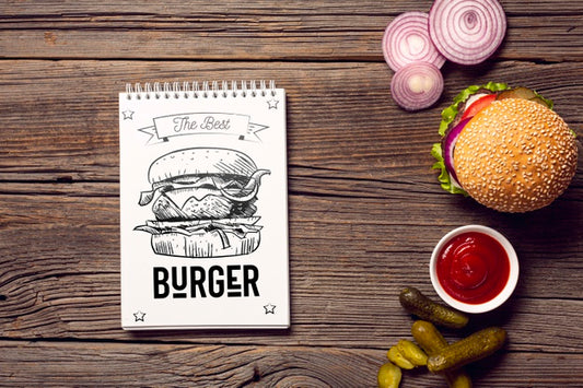 Free Notepad With Burger Sketch On Wooden Background Psd