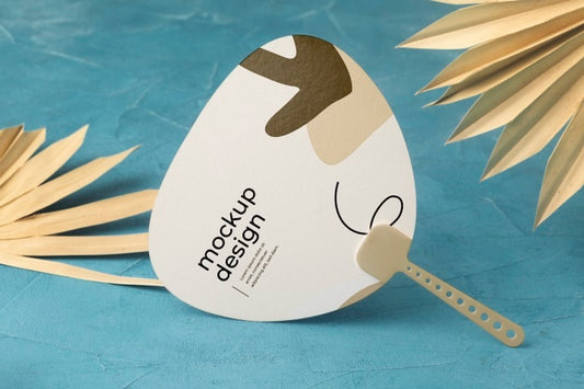 Free Paper Mock-Up Hand Fan With Dry Leaves Psd