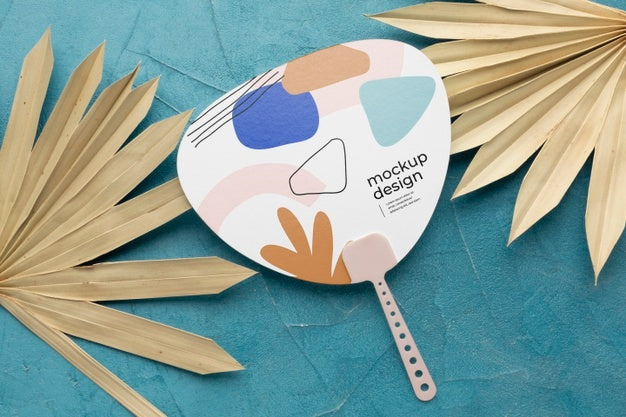 Free Paper Mock-Up Hand Fan With Dry Leaves Psd