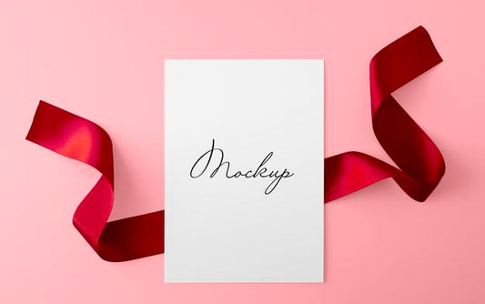 Free Paper Sheet With Red Ribbon Over Pink Surface Mockup Psd