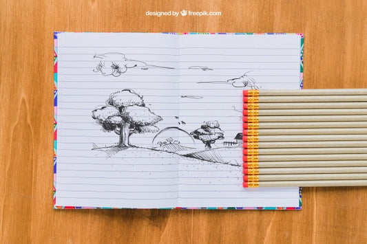Free Pencil Drawing On Notebook, Pencils And Wooden Background Psd