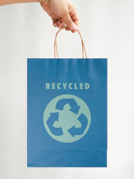 Free Person Holding A Blue Paper Bag Psd