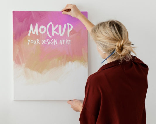Free Person Holding A Canvas Mock-Up Psd