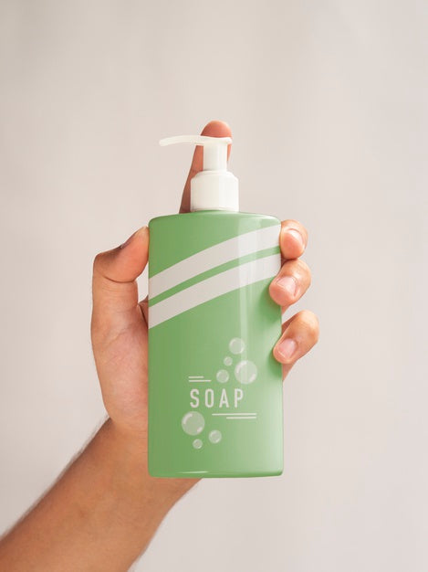 Free Person Holding A Liquid Soap Bottle Close-Up Psd