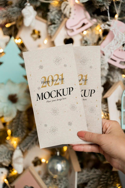 Free Person Holding New Year Mock-Up Cards Psd