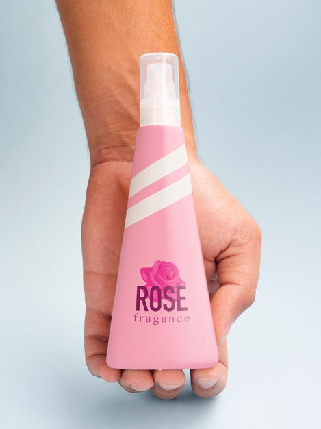 Free Person Holding Pink Fragrance Bottle Mock-Up Psd
