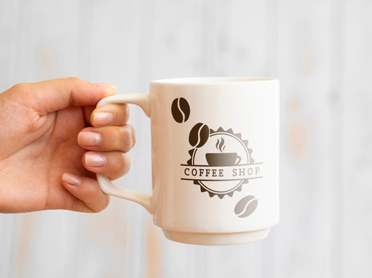 Free Person Holding Up A Coffee Mug Psd