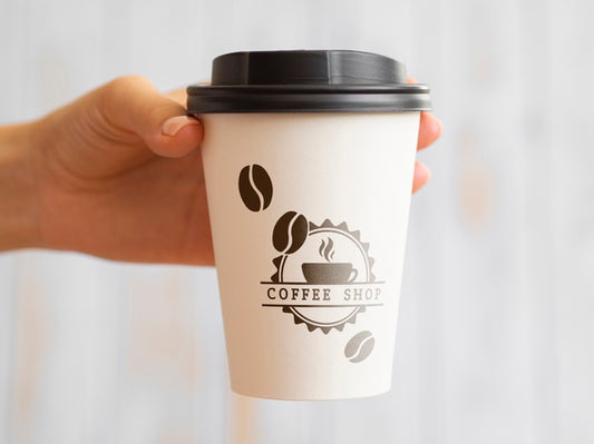 Free Person Holding Up A Coffee Paper Cup Psd