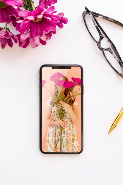 Free Phone Mock-Up Near Flowers And Glasses Psd