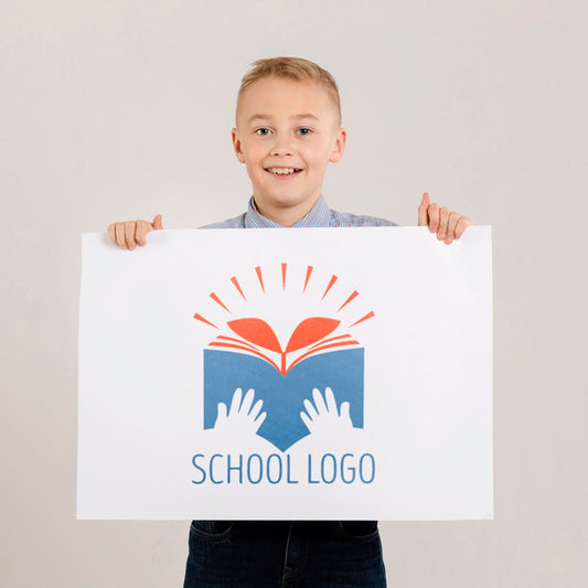 Free Portrait Of Happy Boy Holding Mock-Up Sign Psd