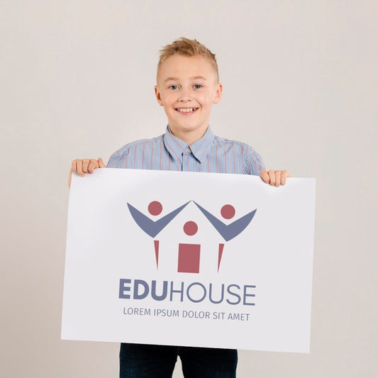 Free Portrait Of Young Boy Holding Mock-Up Sign Psd