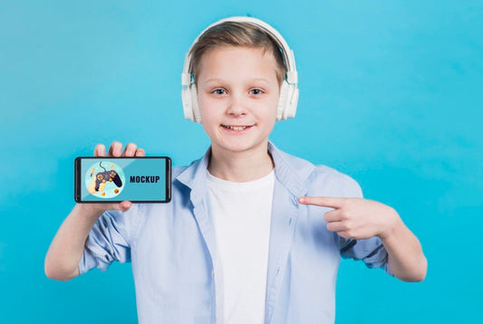 Free Portrait Of Young Boy Holding Phone With Mock-Up Psd