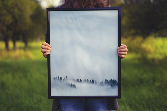 Free Women Holding a Poster Frame Mockup
