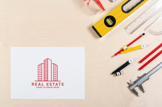 Free Real Estate Logo With Buildings And Stationery Items Psd