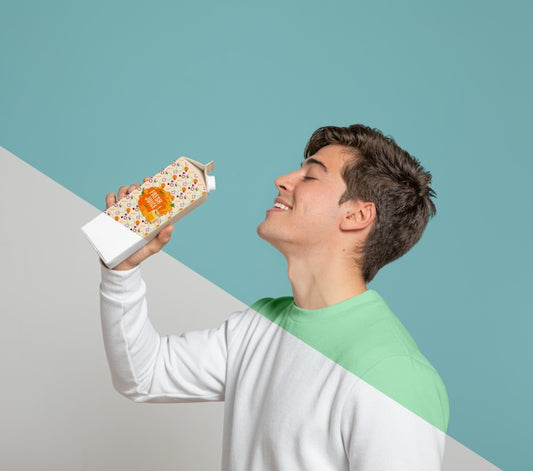 Free Side View Of Man Drinking Out Of Juice Carton Psd