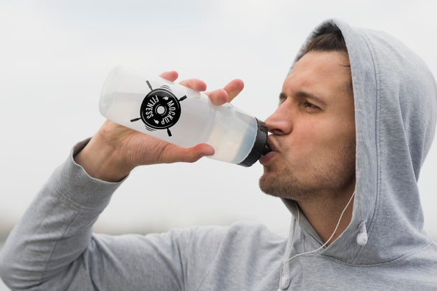 Free Side View Of Man Drinking Water While Working Out Psd