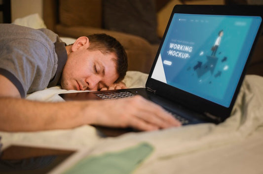 Free Side View Of Man Falling Asleep While Working On Laptop Psd