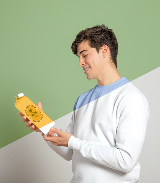 Free Side View Of Man Holding Juice Carton Psd