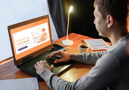 Free Side View Of Man Working From Home On Laptop Psd