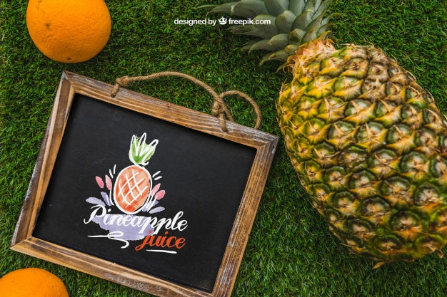 Free Slate And Pineapple On Grass Psd